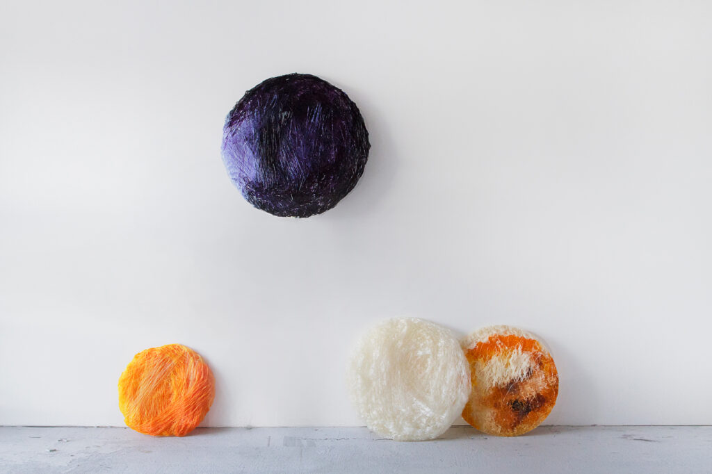 Bioplastic Universe (2018) is a series of lighting objects by cp!s. When the switch is turned on, the objects, which seem like yarn bundles, cast their own shades and create the appearance of the Earth, the moon, and Mars. © Andrej